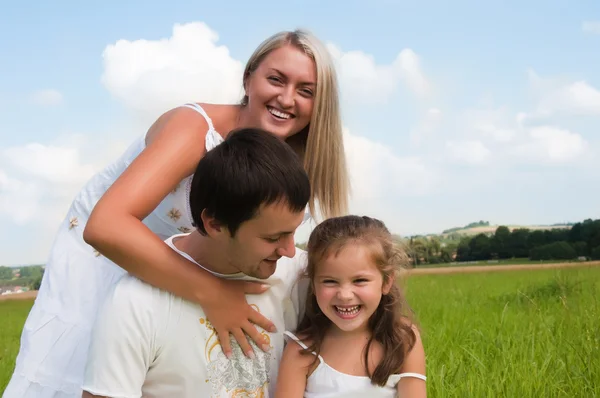 Playful family on the meadow — Stock Photo, Image