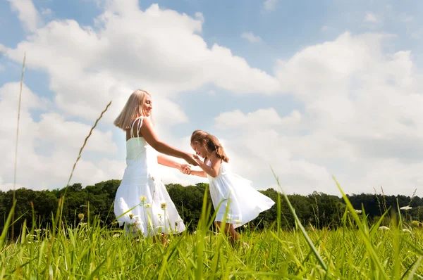 Mother and daughter in summer field — Stock Photo, Image