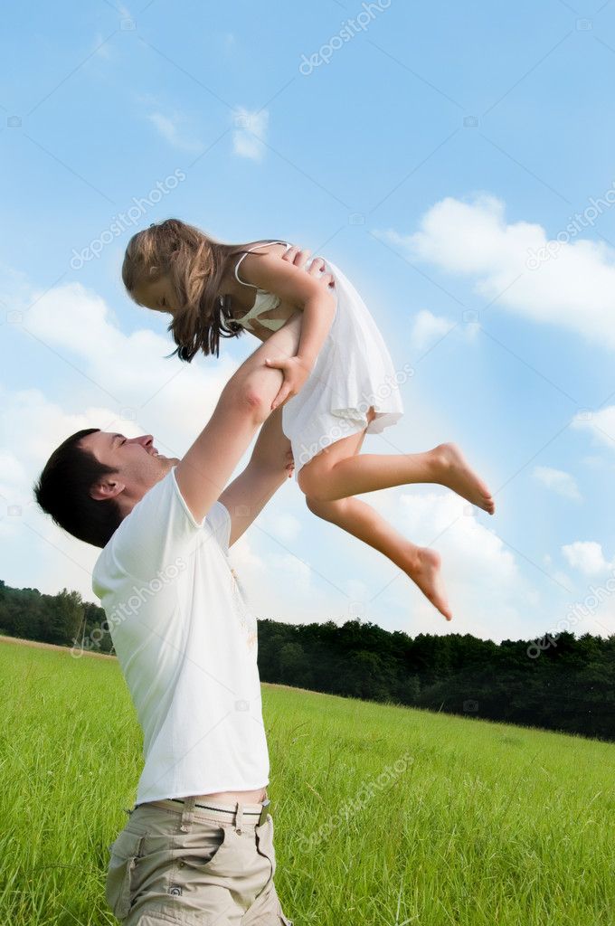 Father and daughter playing in the meadow
