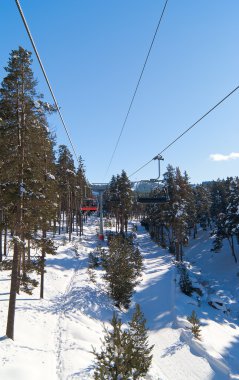 Chairlift in winter forest clipart