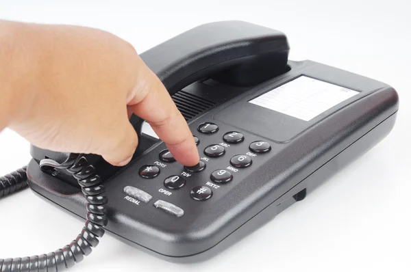 stock image A hand dialing phone number