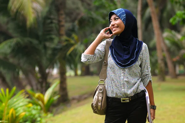 Bonito jovem muçulmano senhora sorriso enquanto conversa com o telefone — Fotografia de Stock