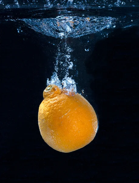 Stock image Orange dropped in water.