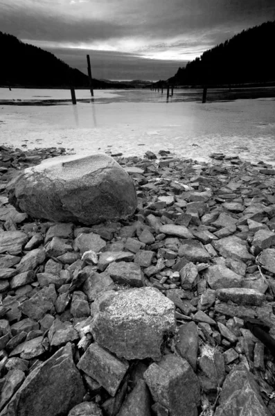 B & W of partially frozen lake . — стоковое фото