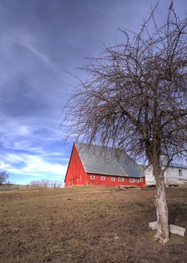 Red barn by a dirt field. clipart