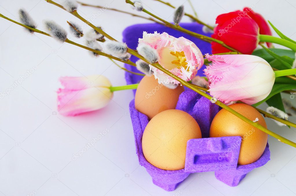 Eggs with tulip flowers and willow branches