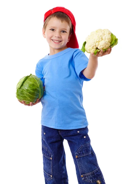 Smiling boy with cabbage and cauliflower — Stock Photo, Image