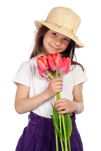 Smiling little girl with red tulips — Stock Photo, Image