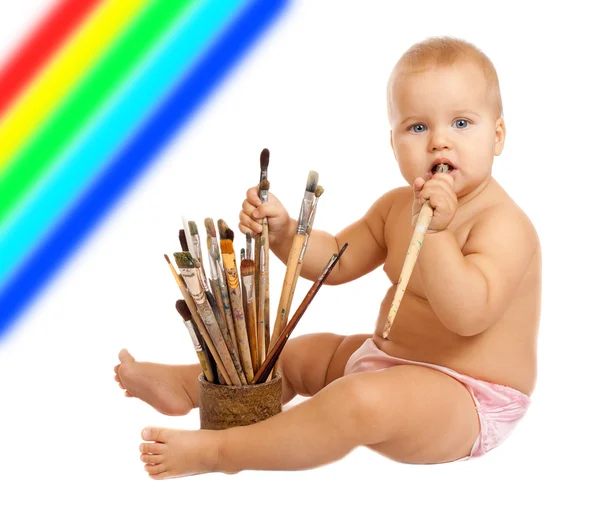 Little baby with paintbrushes — Stock Photo, Image