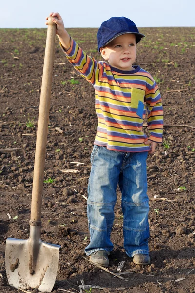 Little children with big shovel Stock Photo