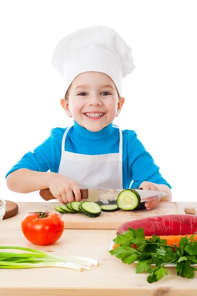 Little boy cutting the cucumber — Stock Photo, Image