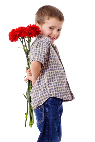 꽃다발을 숨기고 웃는 소년 스톡 사진