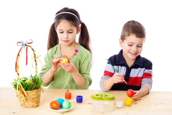 Two kids painting easter eggs — Stock Photo, Image
