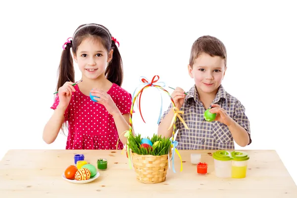 Two kids painting easter eggs — Stock Photo, Image