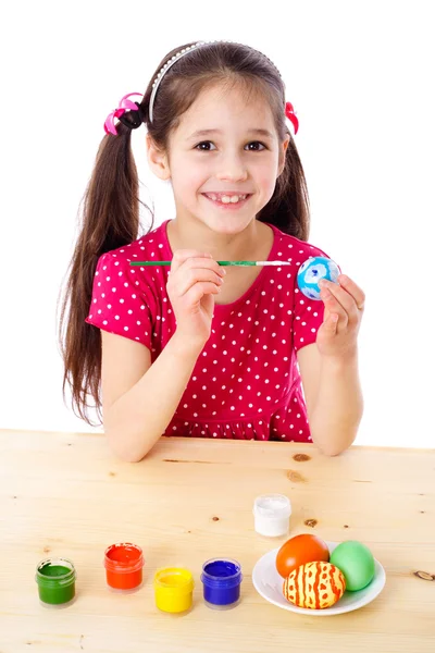Smiling girl painting easter eggs — Stock Photo, Image
