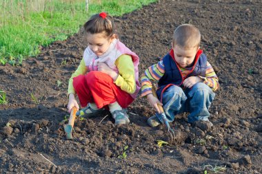 Two little children weed beds clipart