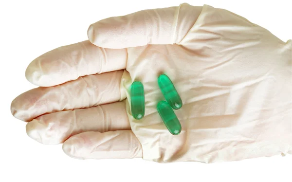 Hand with gloves and pills — Stock Photo, Image