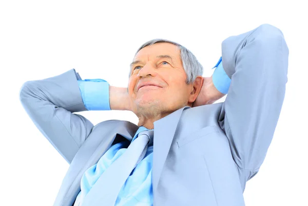 Nice businessman at the age, arms folded behind his head. Isolated on a white background. — Stock Photo, Image