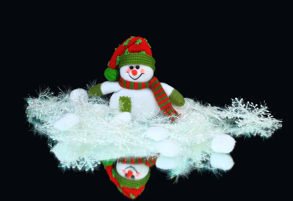 Juguete decorado con un muñeco de nieve, sobre un fondo negro —  Fotos de Stock