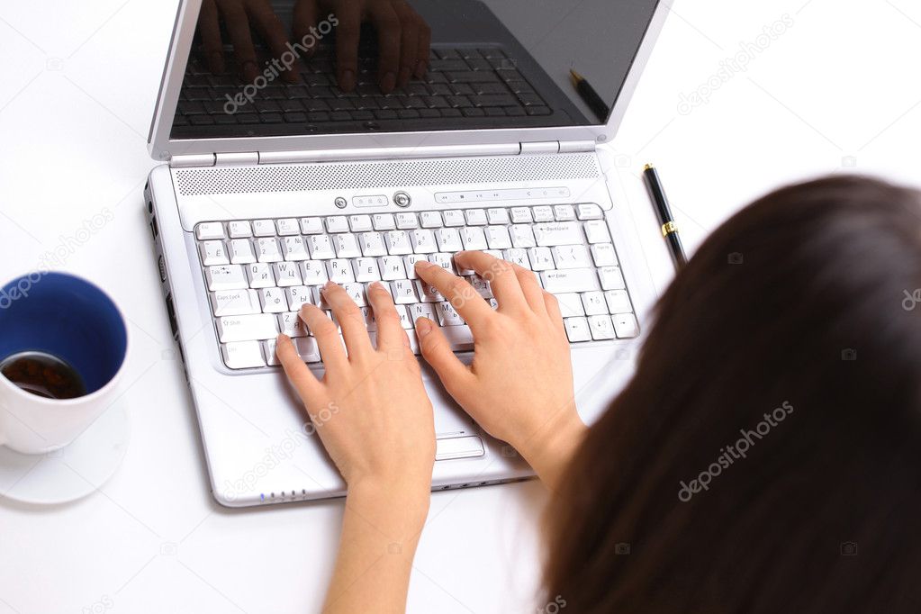Business woman works on a computer. Isolated on white background