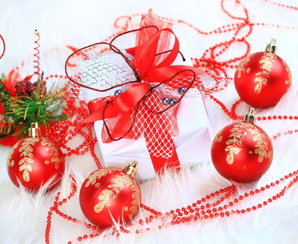 Regalo de Navidad con arco de bolas rojas — Foto de Stock