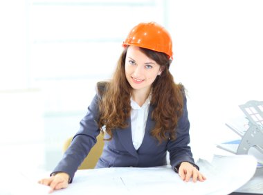 Beautiful businesswoman engineer with the work-plan office. clipart