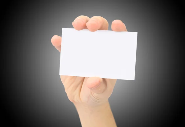 Hand toont blanco visitekaartje. op een zwarte achtergrond. — Stockfoto