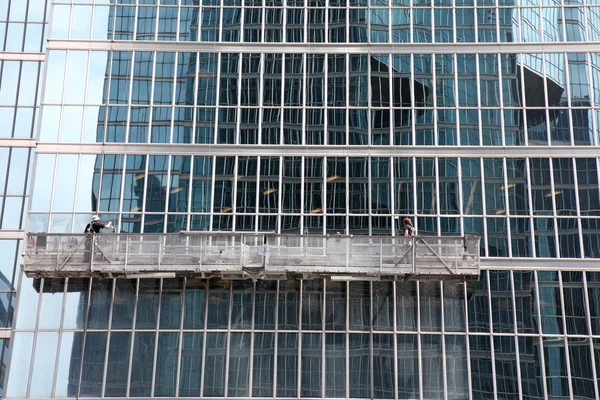 stock image Window washer cleaning windows on a modern highrise office