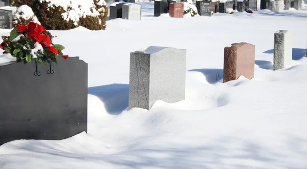 stock image Headstone monuments in graxeyard during winter