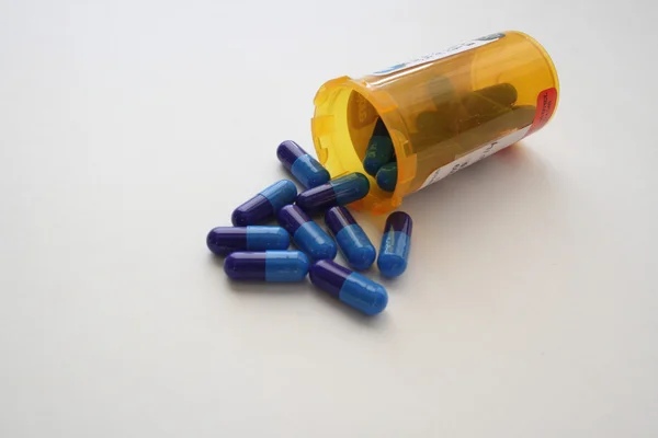 Prescription pills coming out of open bottle — Stock Photo, Image