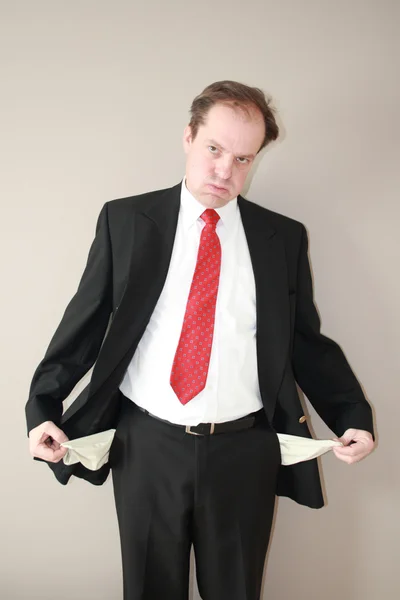Businessman with empty pockets denoting financial loss and frusration — Stock Photo, Image