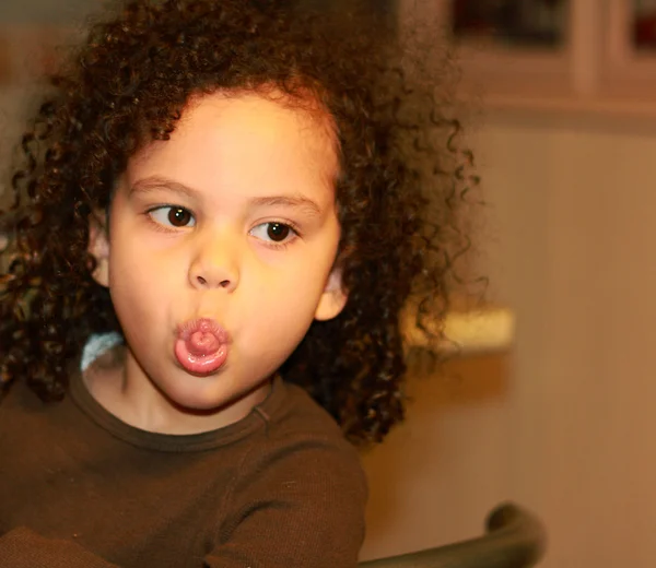 Mixed race child making funny face — Stock Photo, Image