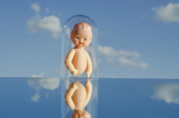 stock image Vintage dolls torso on mirror and sky