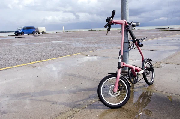 Bicycle after rain on sea wharf — Zdjęcie stockowe