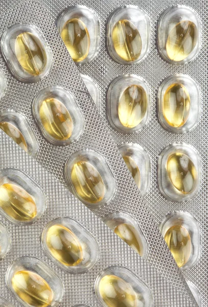 Tre blåsor av gult piller, makro — Stockfoto