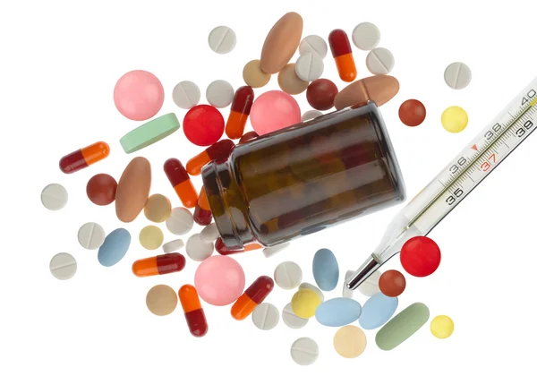 Colored pills spilled around — Stock Photo, Image