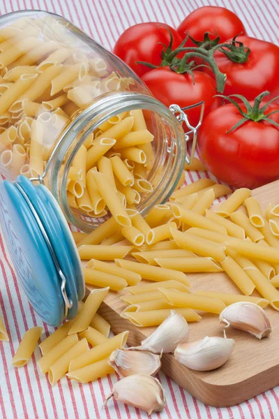 Glass jar and penne rigate — Stock Photo, Image