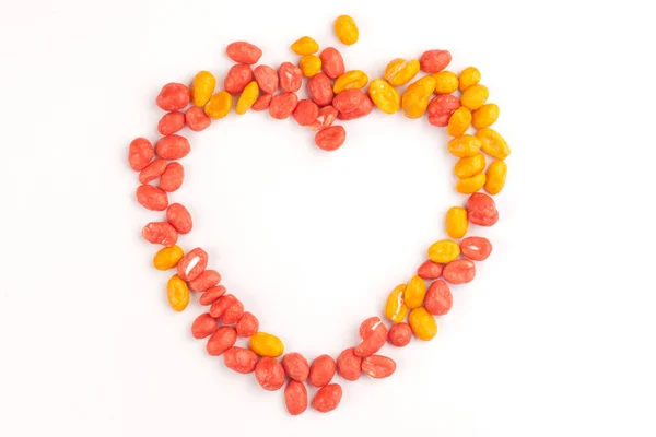 Dragees of peanuts make a contour of the heart — Stock Photo, Image