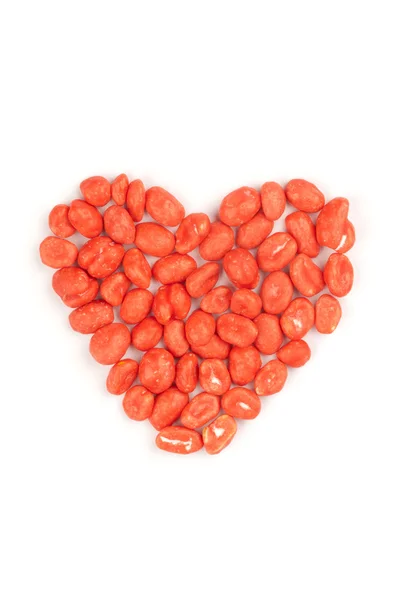 Red heart made of dragees of peanuts, isolated — Stock Photo, Image