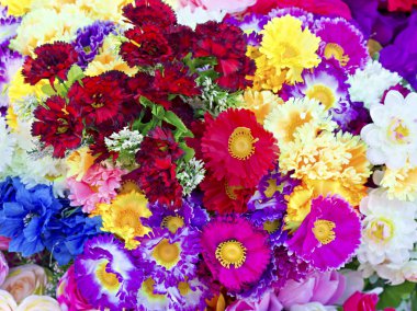 Background of colorful artificial flowers clipart