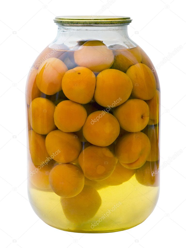 Glass jar with a compote of canned apricots