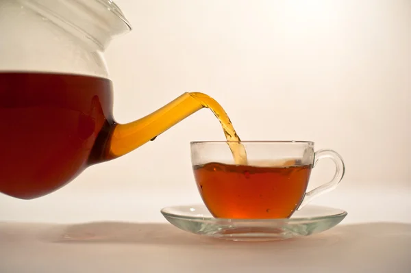 stock image Hot tea is poured into a cup