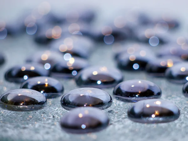 Glass pebbles on crystal — Stock Photo, Image