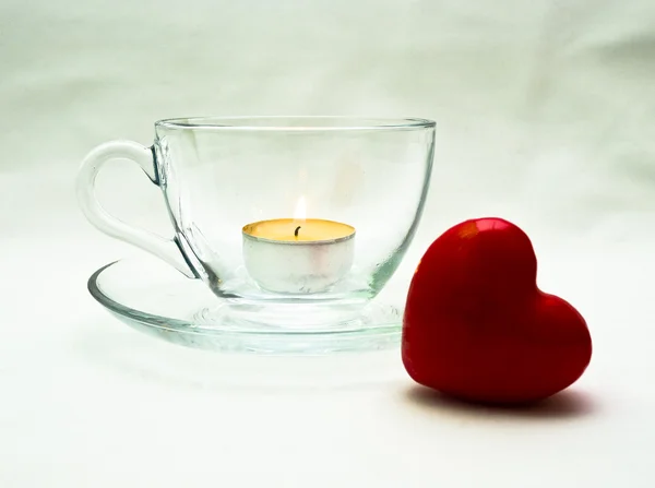 stock image Still life wiht glass cup and red heart and candle