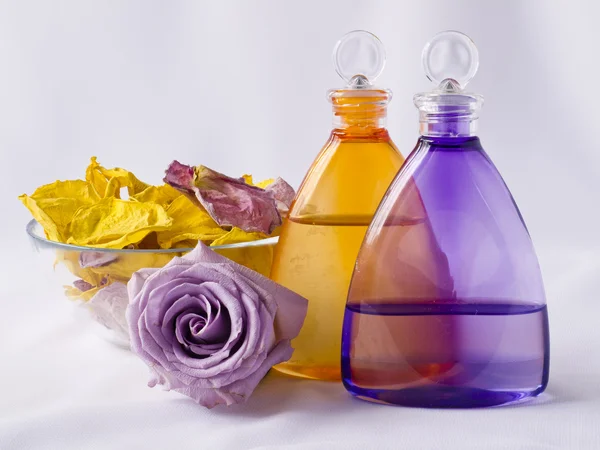 Lavender and arnica oil, rose petals — Stock Photo, Image