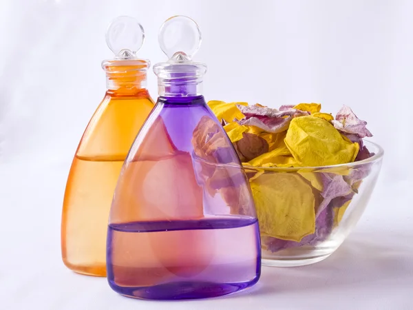 Lavender and arnica oil, rose petals — Stock Photo, Image