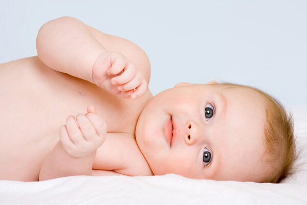 Happy the child is lying on its side and looks towards
