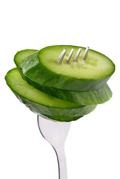 stock image The green cucumber is cut on a part and a fork