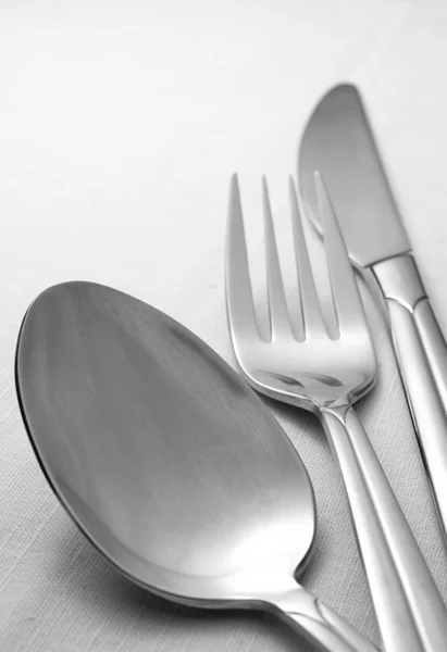 Gabel, Löffel und Messer auf einer Serviette auf dem Tisch — Stockfoto