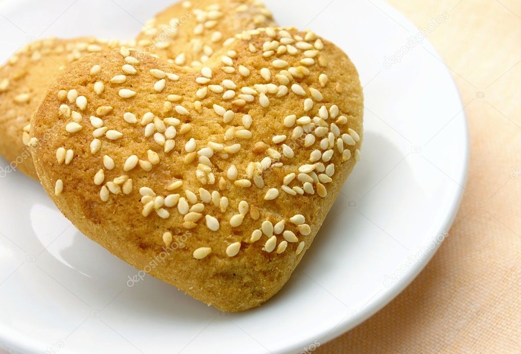 Cookies in the form of heart with sesame seeds on a plate